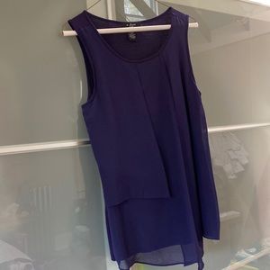 Purple sleeveless blouse with tiered front.